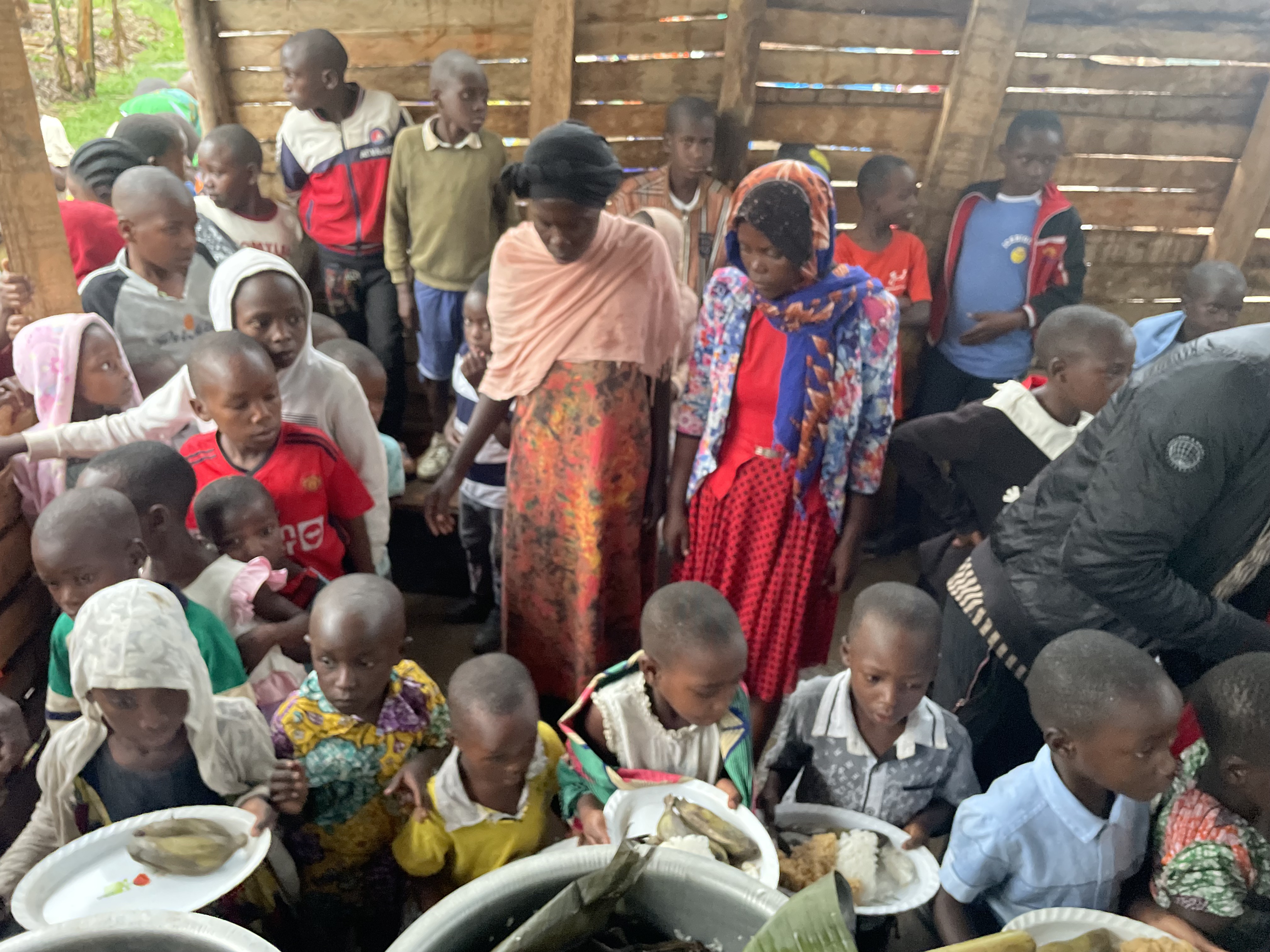 Children and community members gathered during the New Life Pentecostal Church Uganda mission